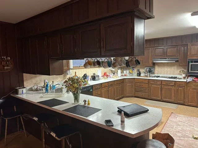 a kitchen with a sink cabinets and wooden floor