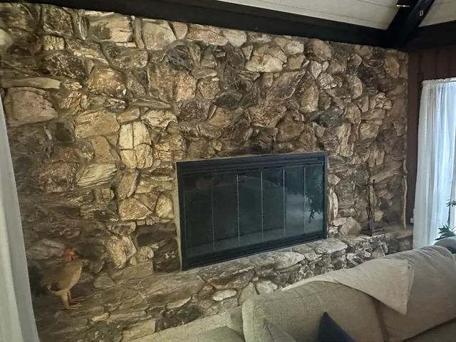 a bedroom with a bed and a fireplace