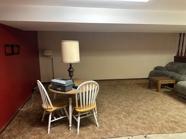 a dining room with furniture and a lamp