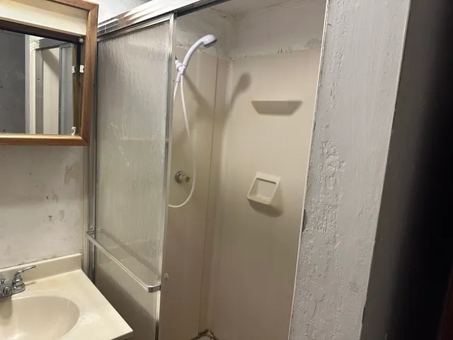 a picture of a bathroom with a shower