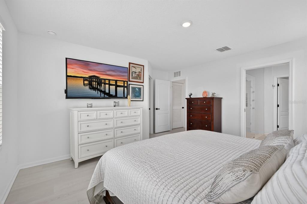 336 Redbud Road Palm Coast, FL 32137 - Photo 14 of 40 a bedroom with a bed and a flat screen tv