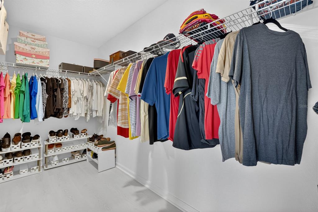336 Redbud Road Palm Coast, FL 32137 - Photo 15 of 40 a view of walk in closet with clothes and shoes