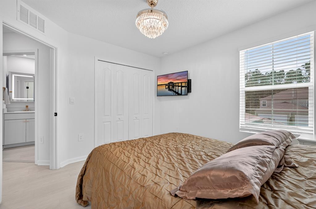 336 Redbud Road Palm Coast, FL 32137 - Photo 17 of 40 a bedroom with a bed and a window