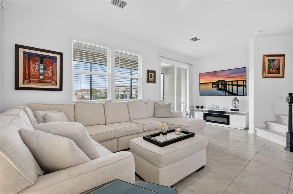 336 Redbud Road Palm Coast, FL 32137 - Photo 23 of 40 a living room with furniture a flat screen tv and a window
