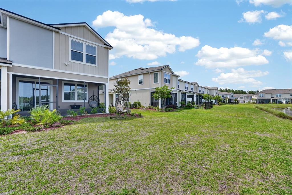 336 Redbud Road Palm Coast, FL 32137 - Photo 34 of 40 a front view of a house with yard and green space
