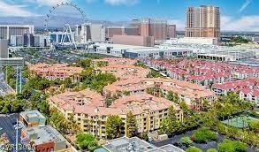 260 East Flamingo Road, Unit 220 Las Vegas, NV 89169 - Photo 27 of 32 An aerial perspective reveals a vibrant community nestled amongst towering urban structures and the iconic Ferris wheel.