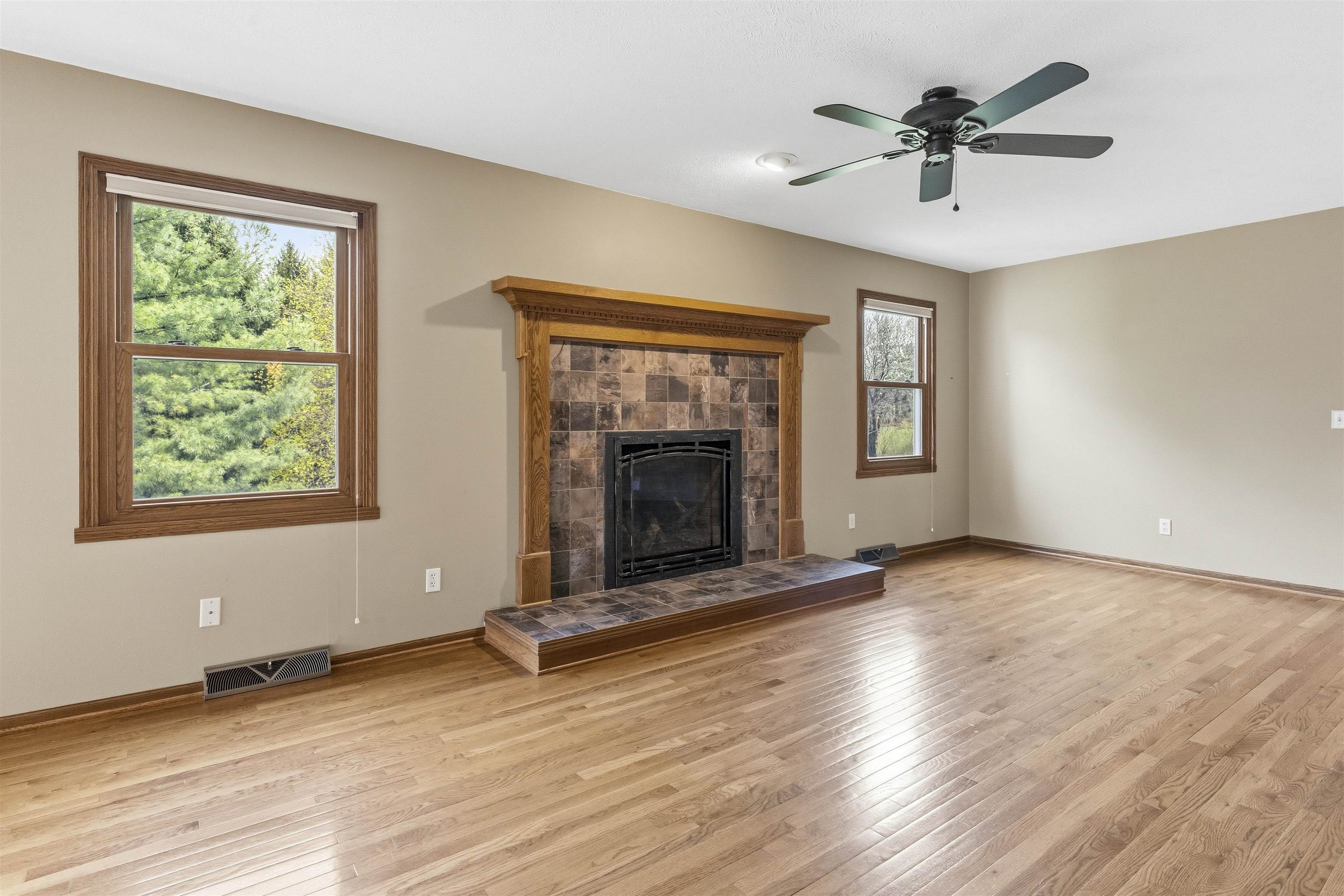6990 Skyview Trail Roscoe, IL 61073 - Photo 11 of 43 a view of an empty room with a window and fireplace