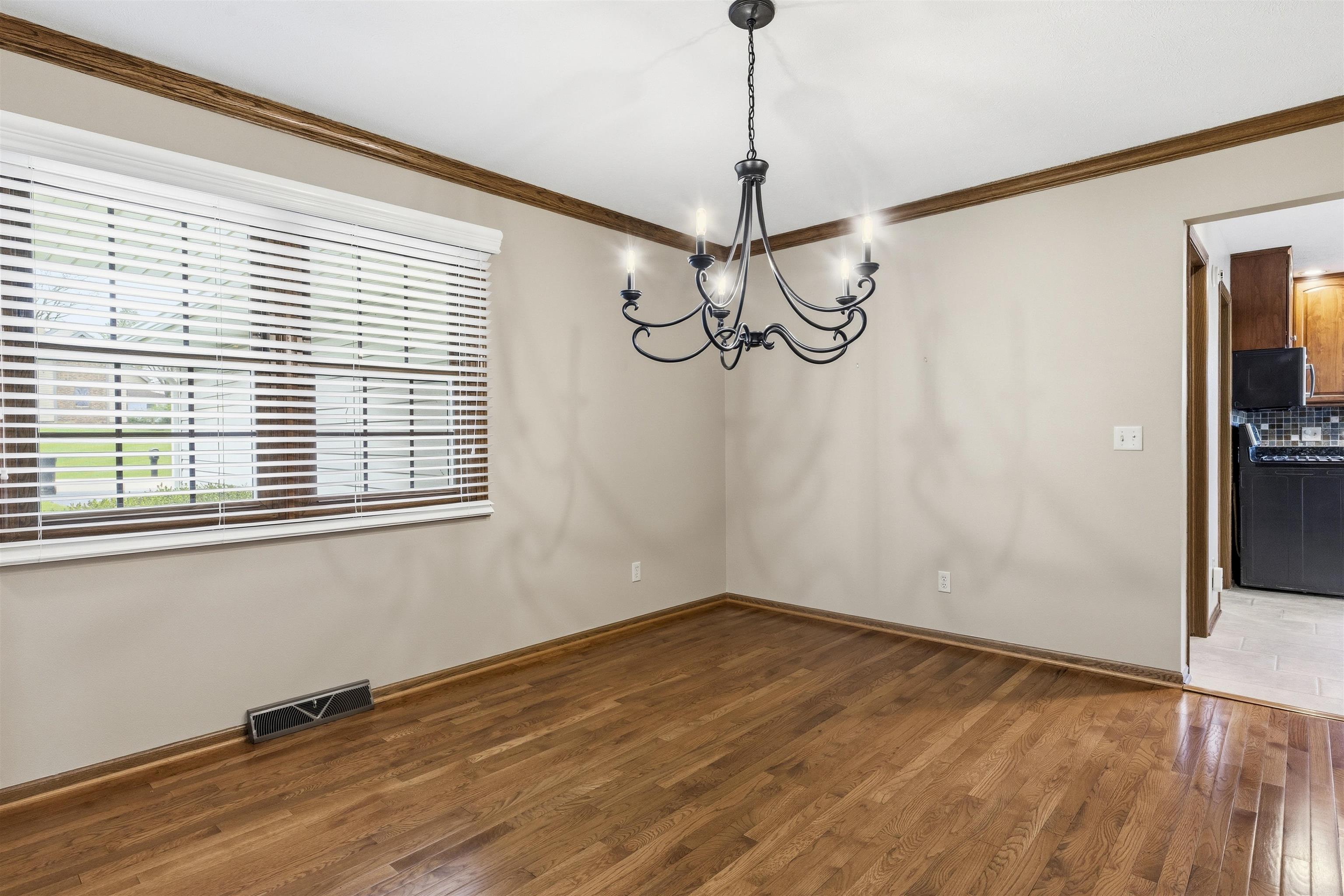6990 Skyview Trail Roscoe, IL 61073 - Photo 14 of 43 a view of a room with wooden floor fan and a window