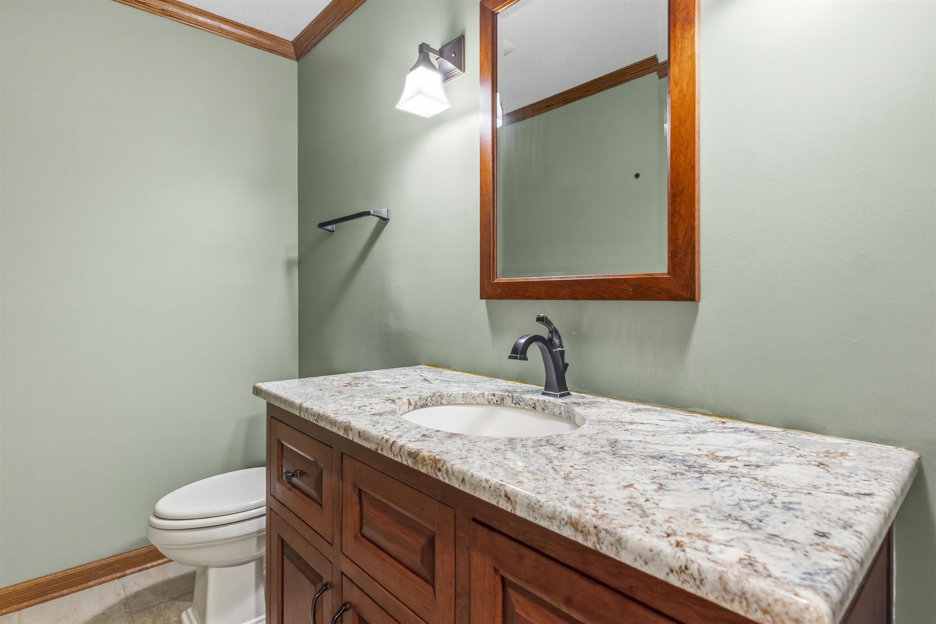 6990 Skyview Trail Roscoe, IL 61073 - Photo 16 of 43 a bathroom with a granite countertop sink a toilet and mirror