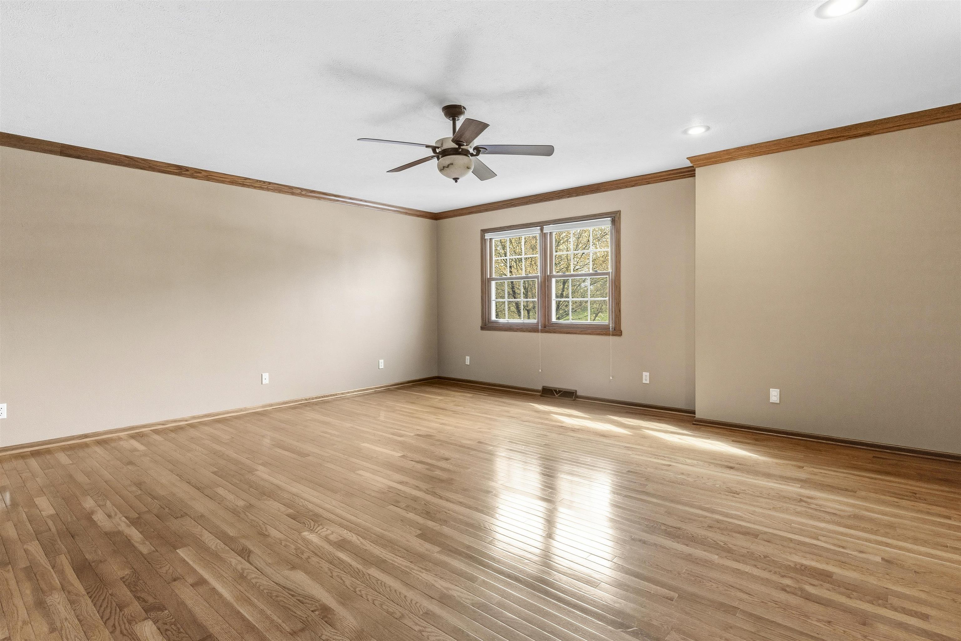 6990 Skyview Trail Roscoe, IL 61073 - Photo 20 of 43 a view of an empty room with a window and wooden floor