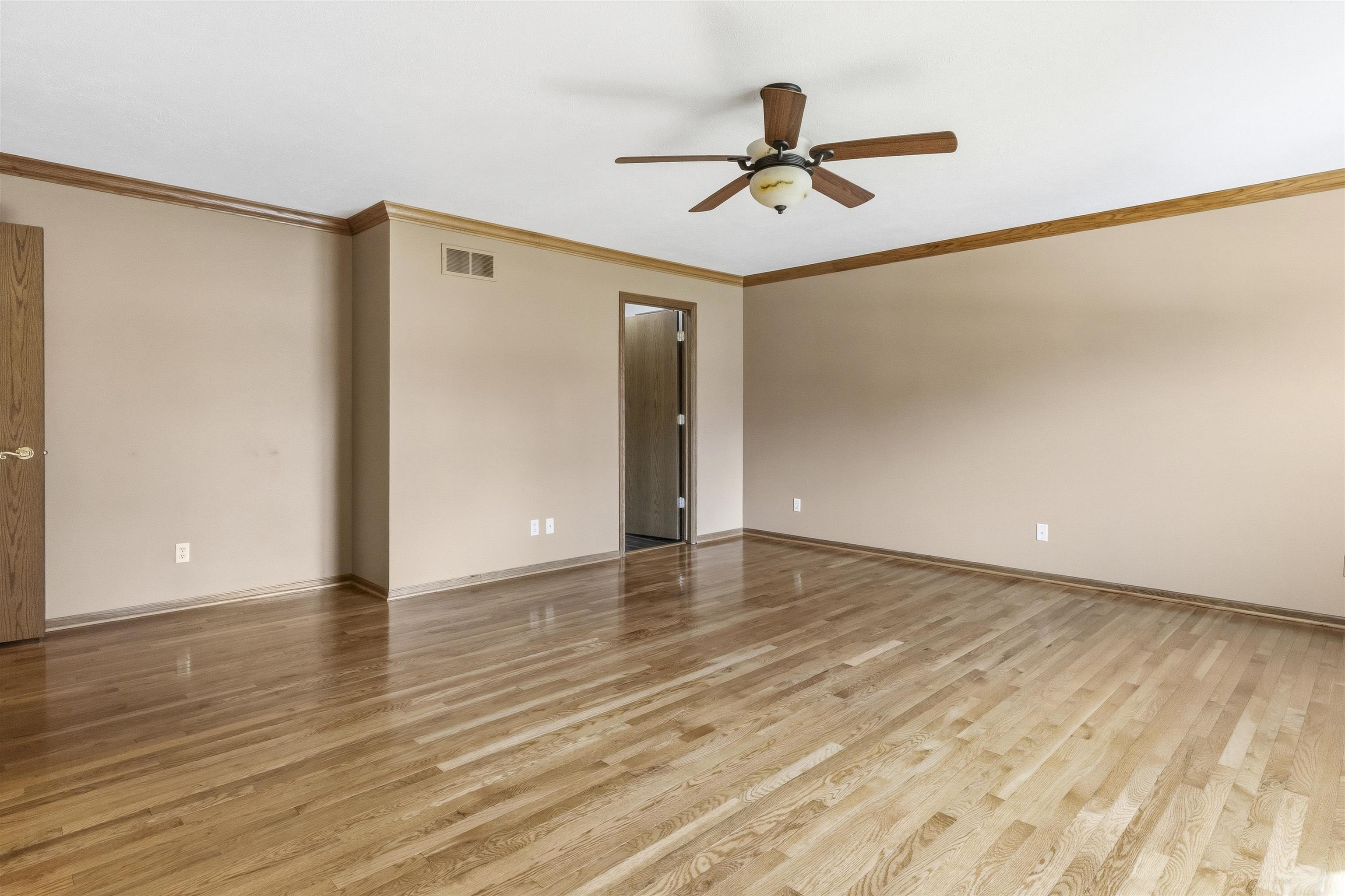 6990 Skyview Trail Roscoe, IL 61073 - Photo 21 of 43 a view of empty room with wooden floor and fan