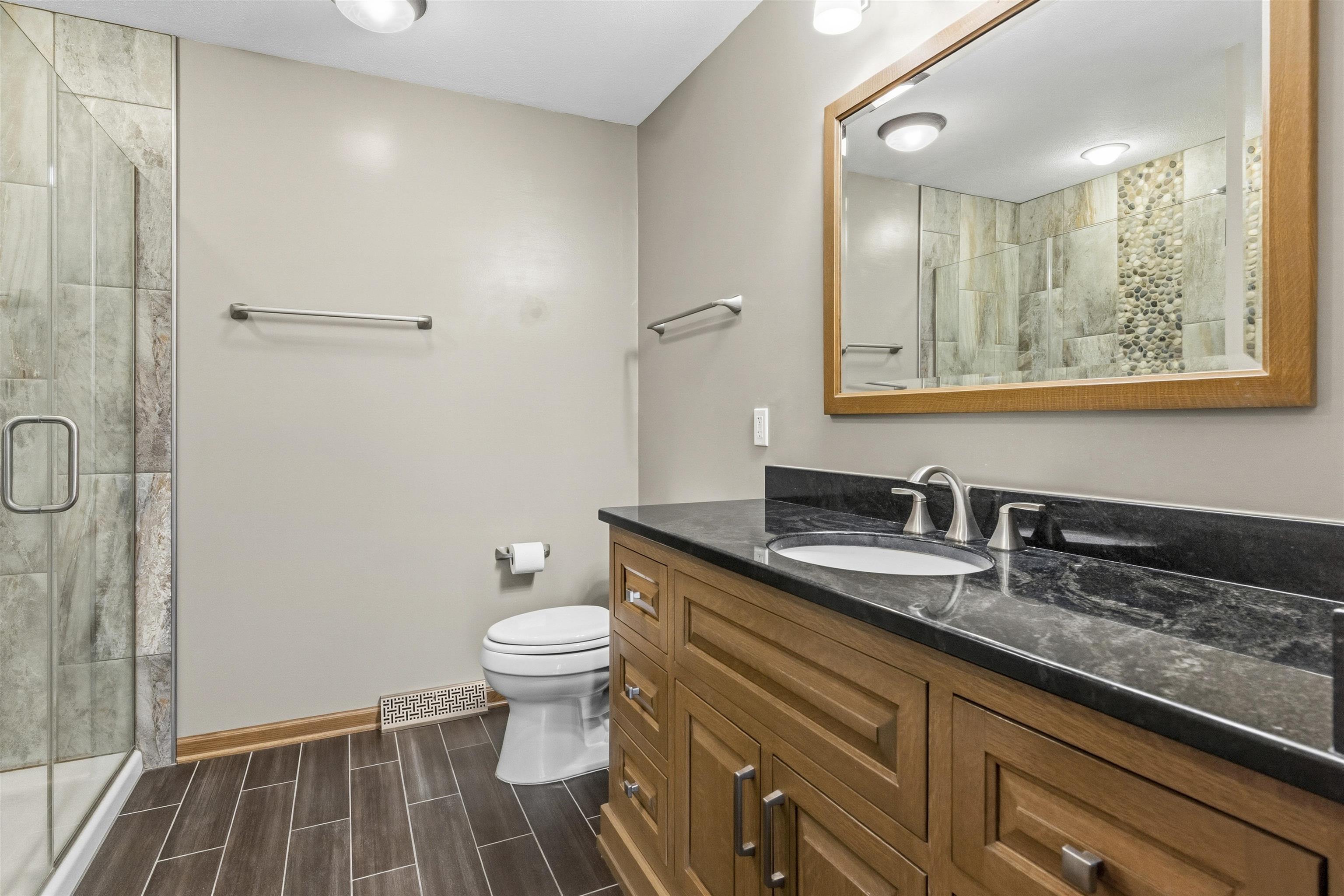 6990 Skyview Trail Roscoe, IL 61073 - Photo 22 of 43 a bathroom with a sink and a mirror