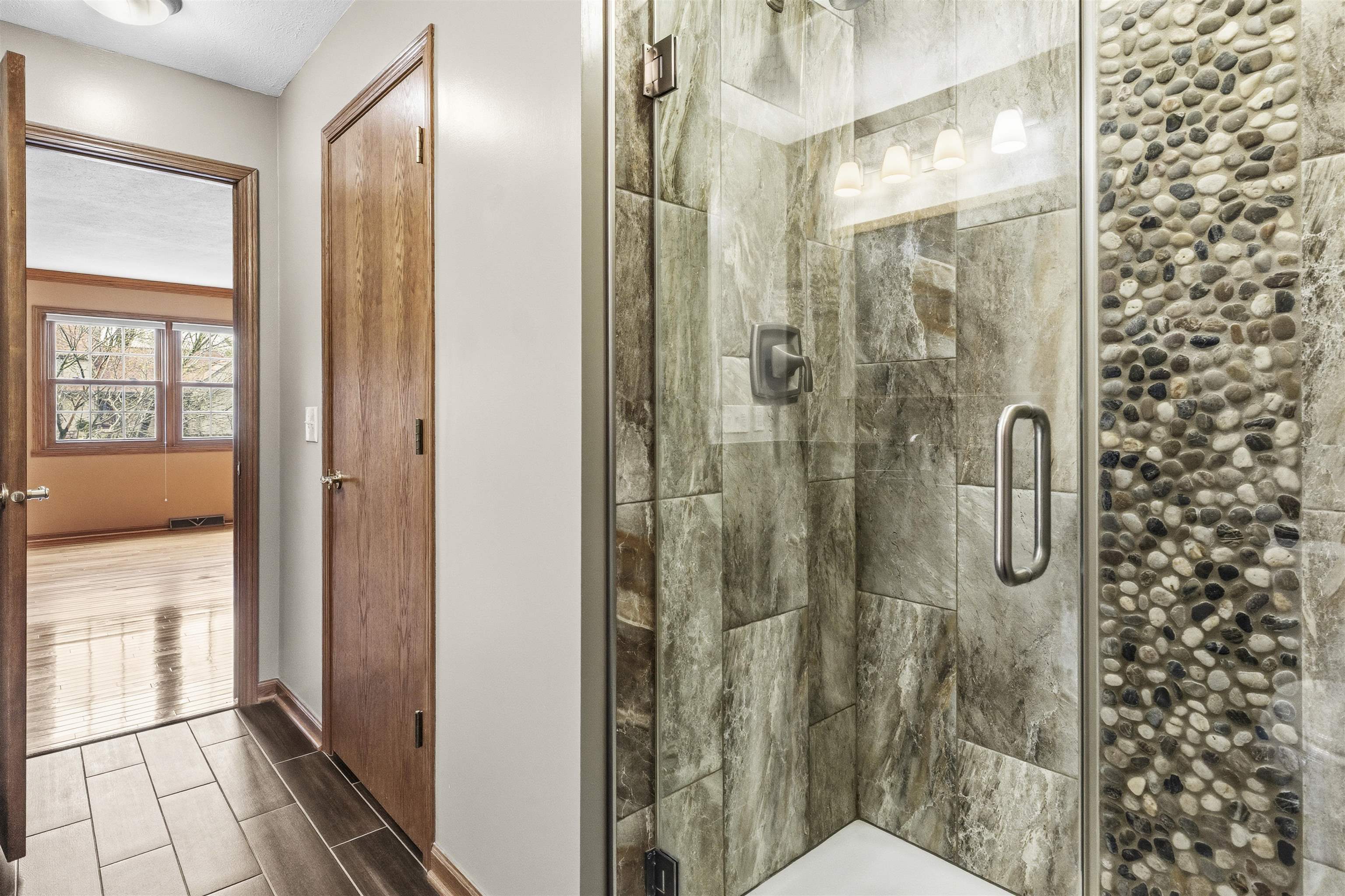 6990 Skyview Trail Roscoe, IL 61073 - Photo 23 of 43 a bathroom with a glass shower door