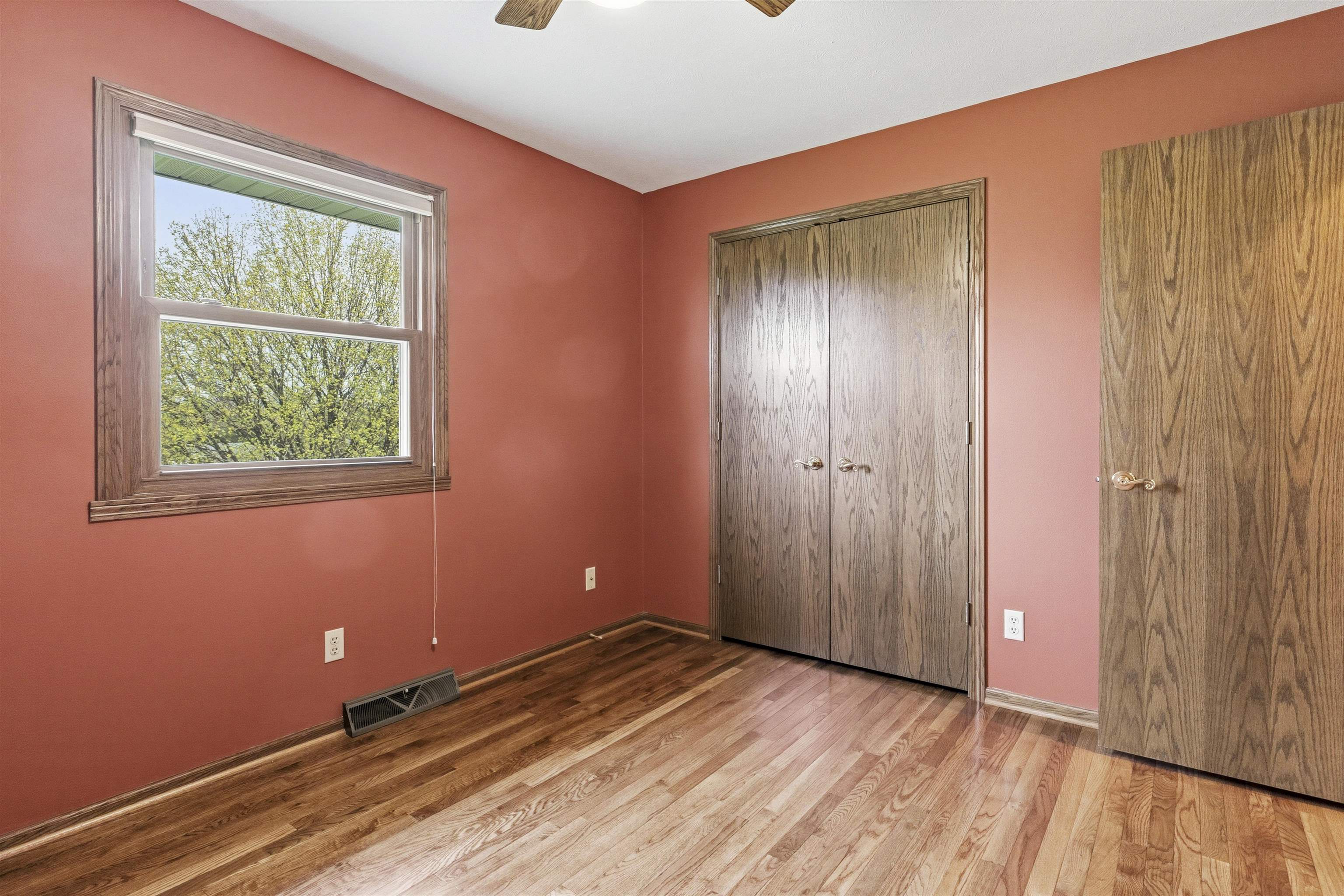 6990 Skyview Trail Roscoe, IL 61073 - Photo 25 of 43 an empty room with wooden floor and windows
