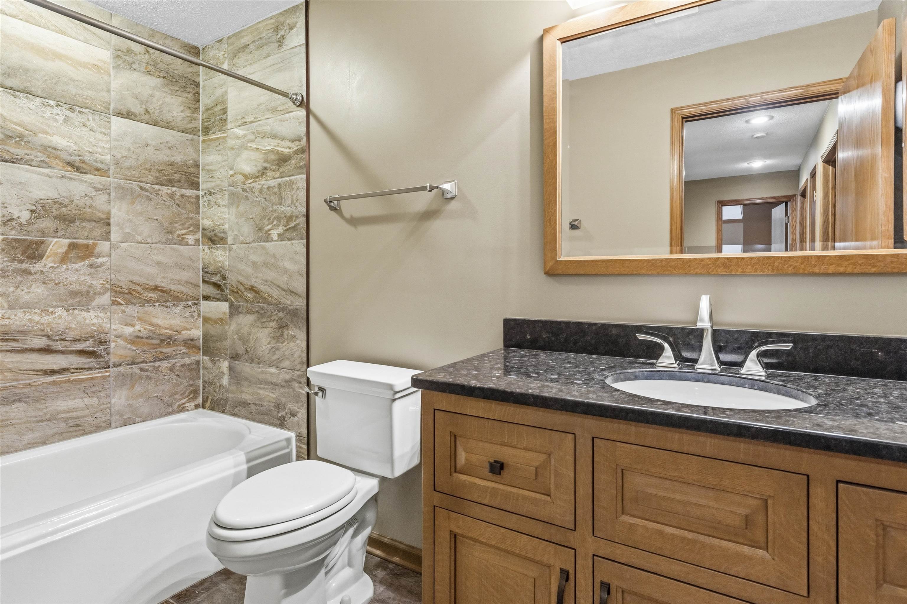 6990 Skyview Trail Roscoe, IL 61073 - Photo 26 of 43 a bathroom with a granite countertop sink toilet and shower