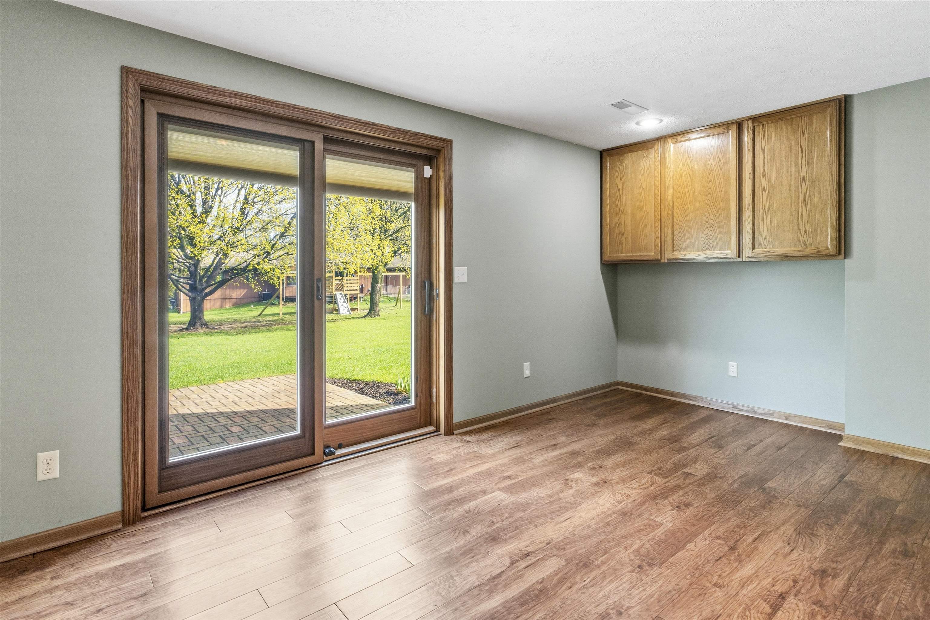 6990 Skyview Trail Roscoe, IL 61073 - Photo 28 of 43 a view of an empty room with wooden floor and doors
