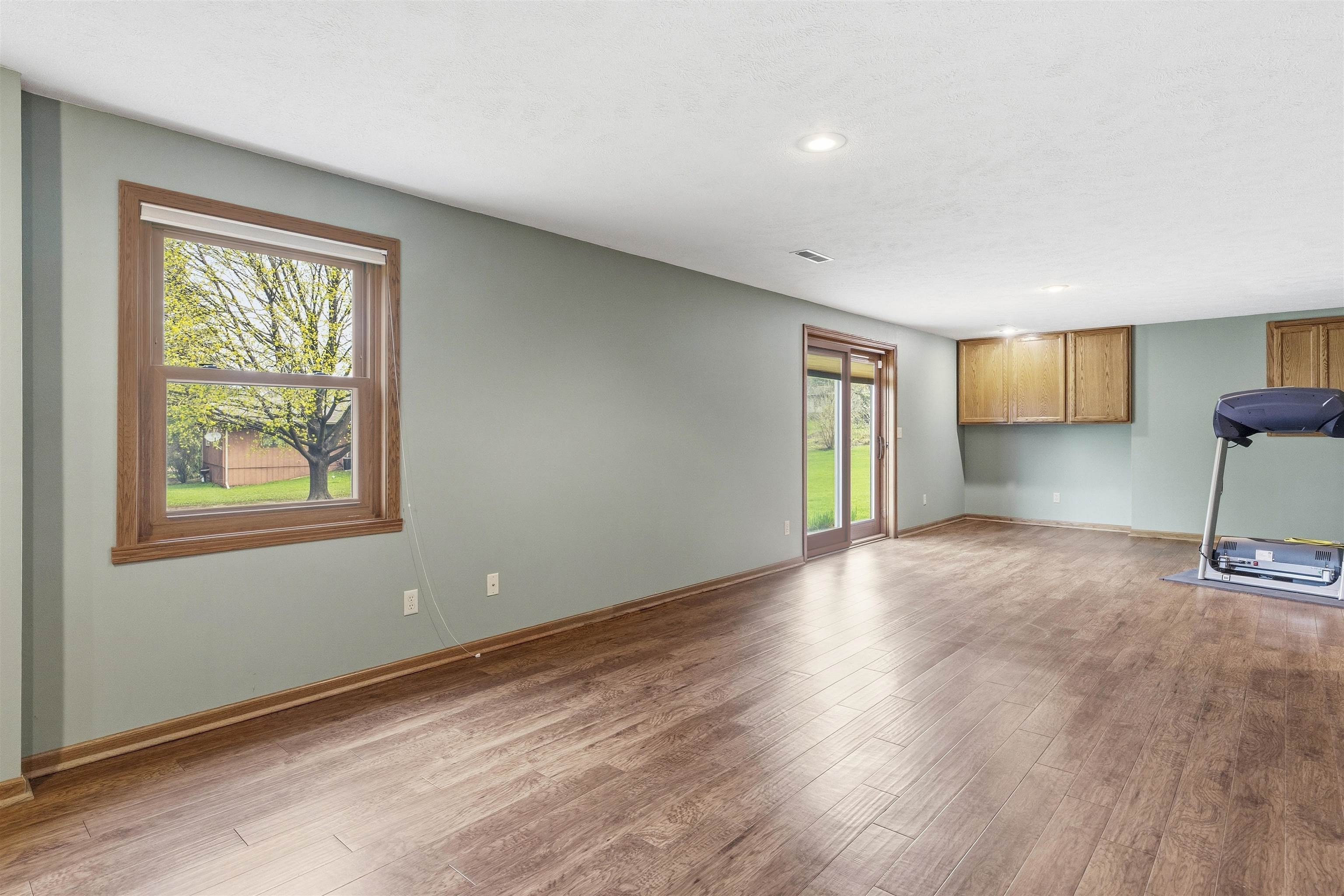6990 Skyview Trail Roscoe, IL 61073 - Photo 29 of 43 a view of empty room with wooden floor and fan