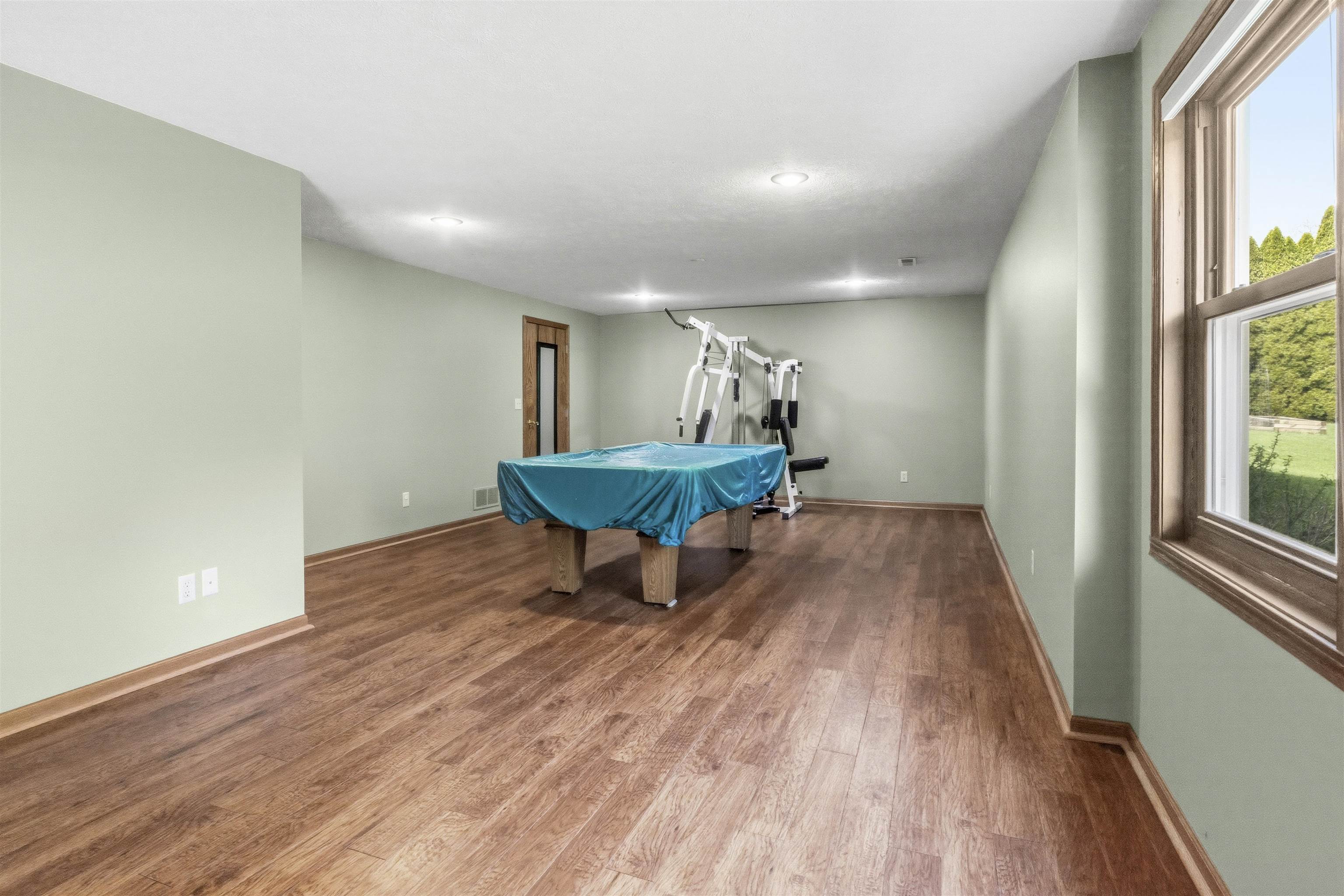 6990 Skyview Trail Roscoe, IL 61073 - Photo 30 of 43 a view of a room with wooden floor and furniture