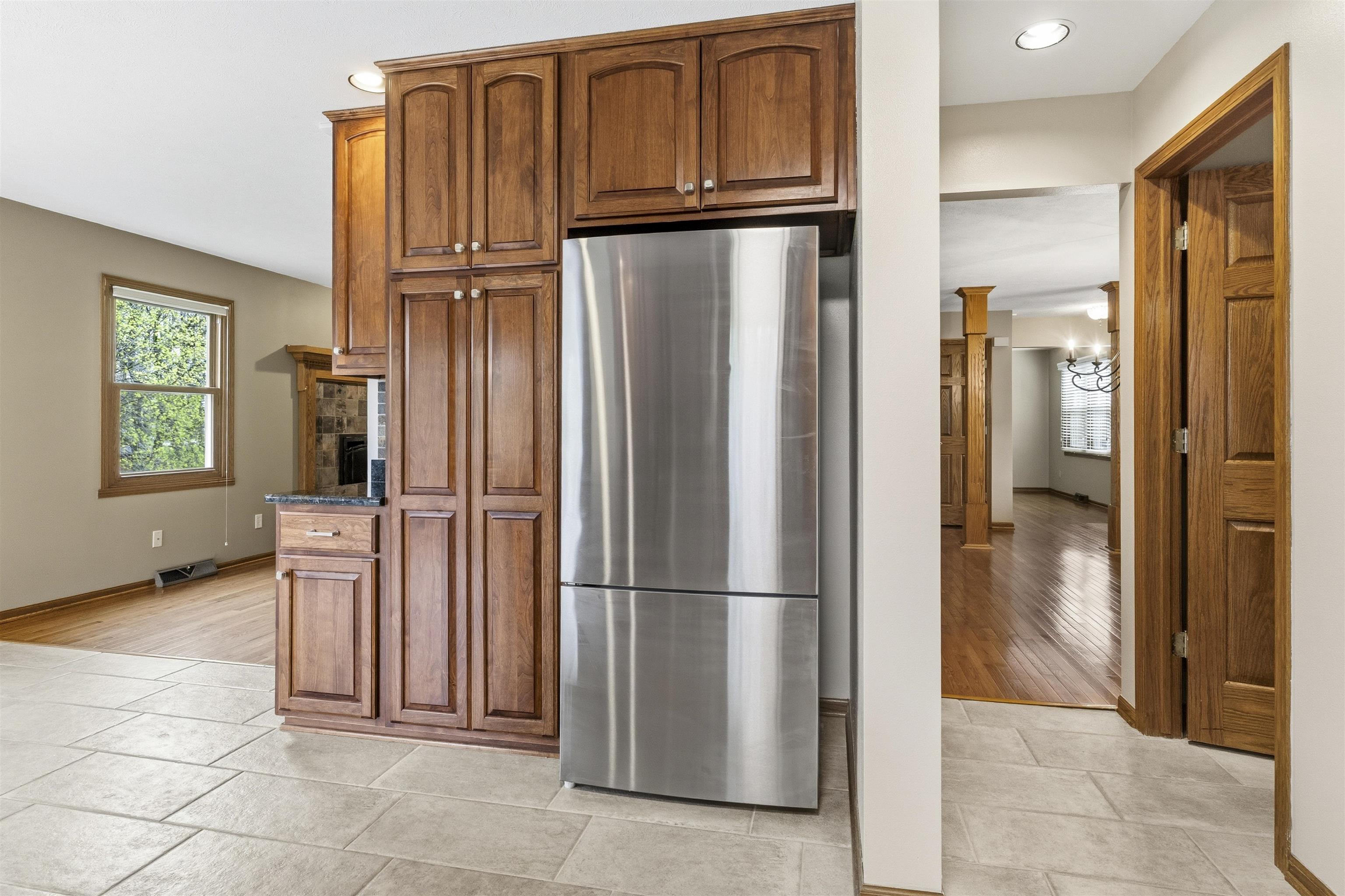 6990 Skyview Trail Roscoe, IL 61073 - Photo 6 of 43 a view of a refrigerator in kitchen and an empty room