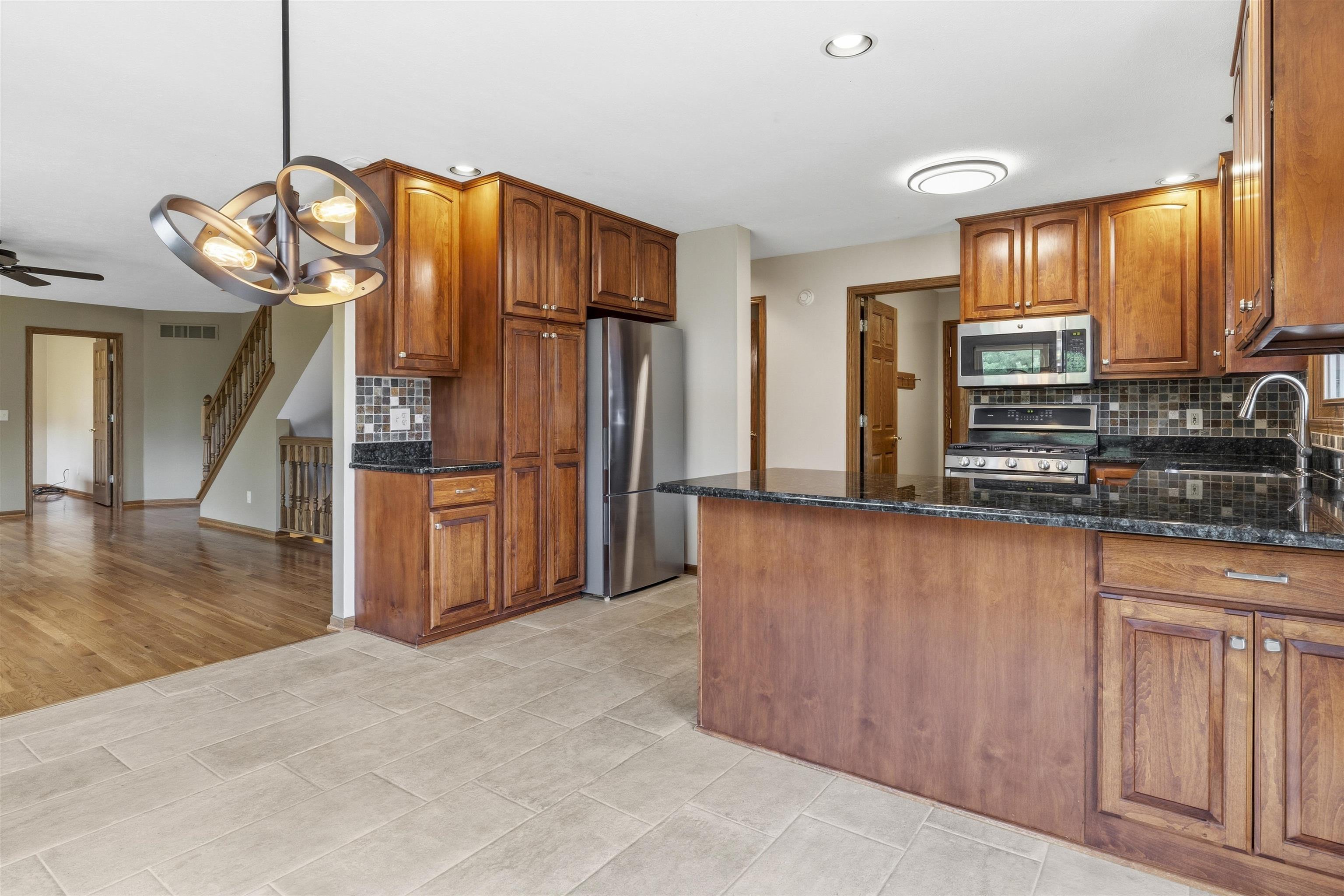 6990 Skyview Trail Roscoe, IL 61073 - Photo 8 of 43 a view of a kitchen with furniture and a window