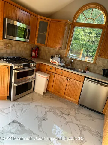 a view of a kitchen with wooden floor and a sink
