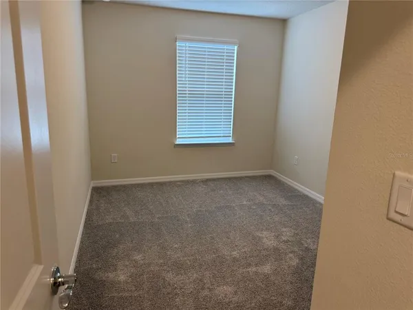 an empty room with closet area