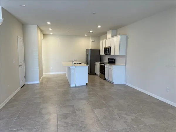 a view of a kitchen with a sink and microwave