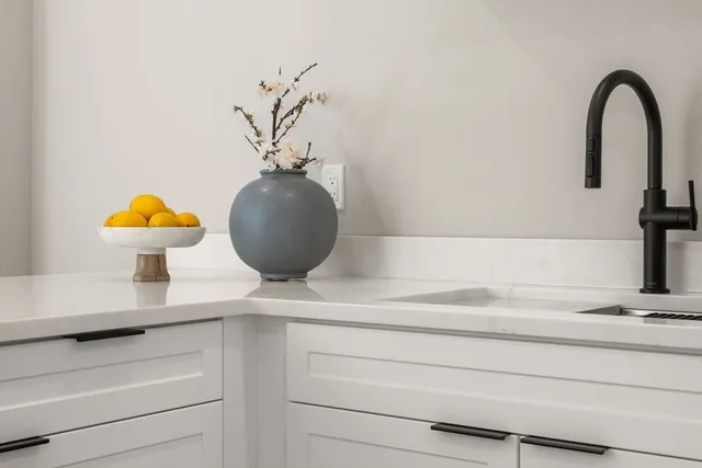 a kitchen with a sink appliances and cabinets