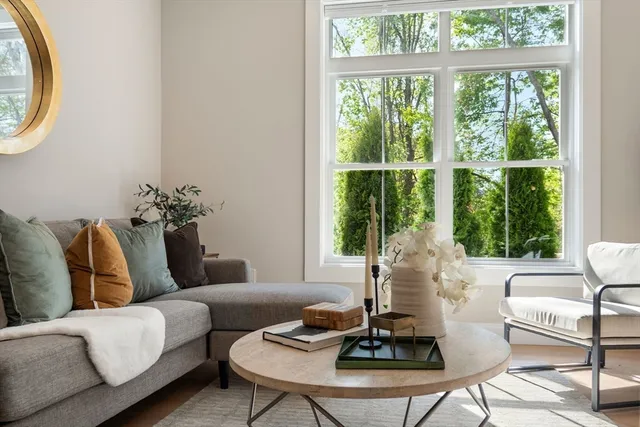 a living room with furniture and a floor to ceiling window