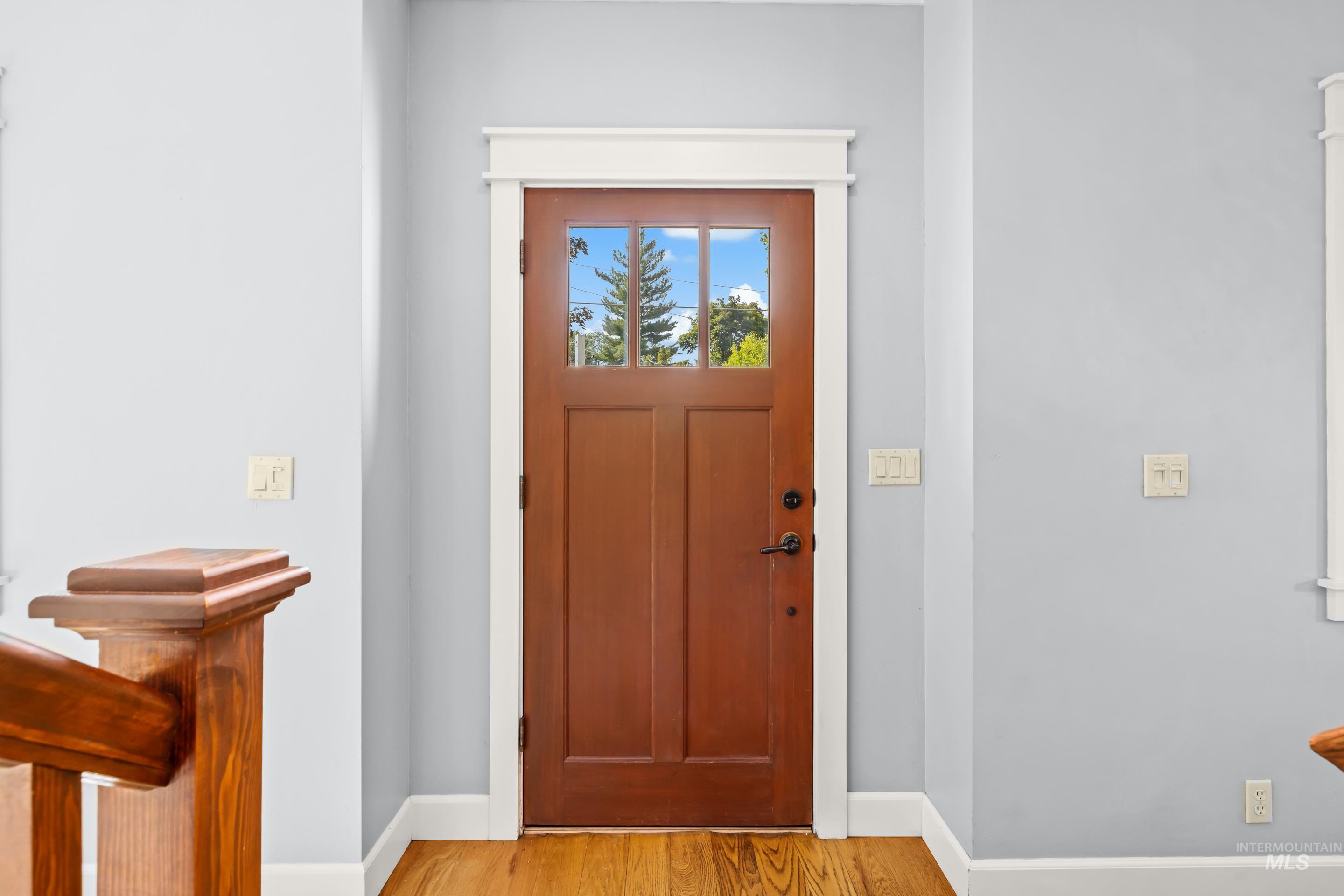 Wood-finish entry door with clear glass panels