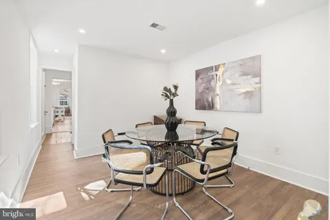 a living room with furniture a rug and a lamp