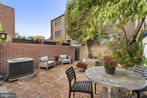 a view of a hallway with wooden floor and a living room