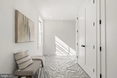 an empty room with a fireplace and wooden floor