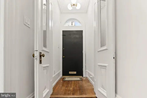 a view of a hallway with wooden floor