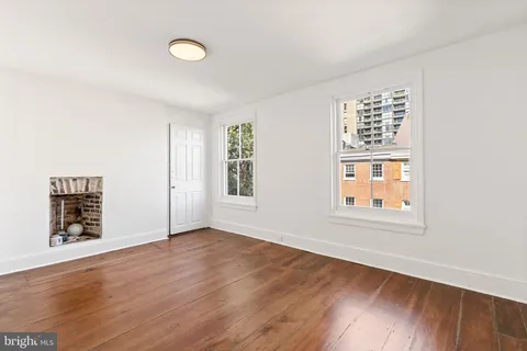 a living room with furniture a mirror and a lamp