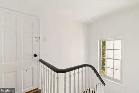 a view of a house with brick walls and floor to ceiling windows