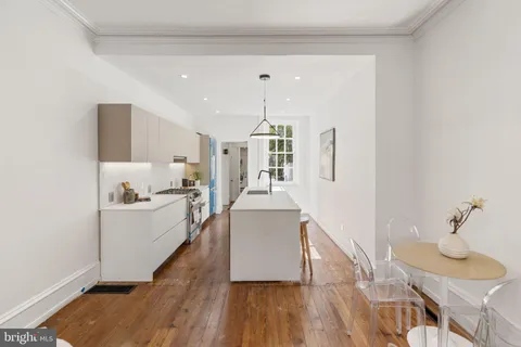 a kitchen with cabinets a sink and appliances