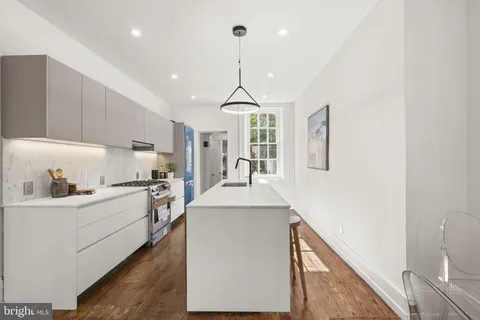 a kitchen with stainless steel appliances a sink stove and refrigerator