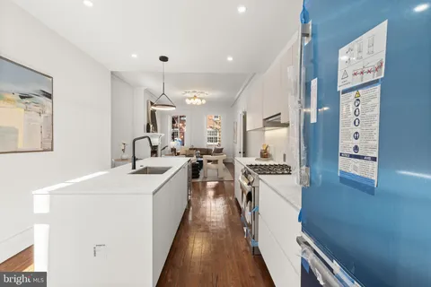 a kitchen with stainless steel appliances kitchen island granite countertop a sink and cabinets