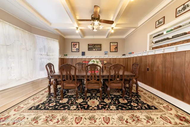 a view of a dining room with furniture and chandelier