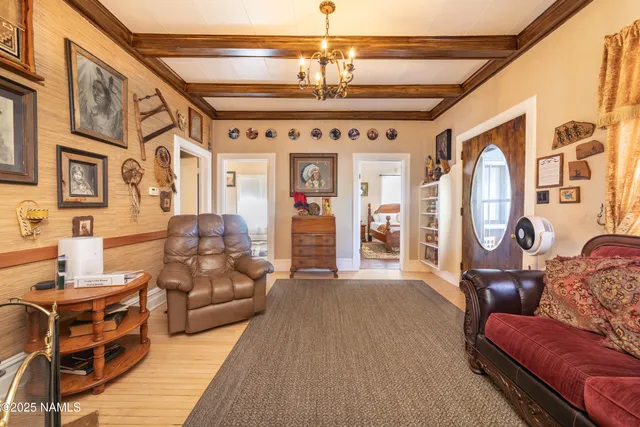 a living room with furniture and a chandelier