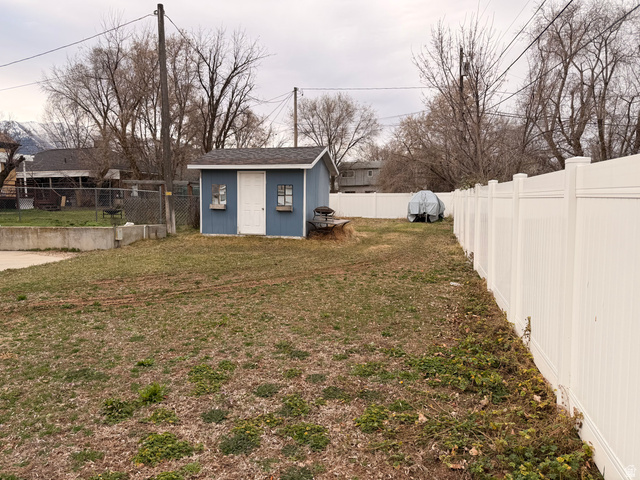 110 South 200 East Springville, UT 84663 - Photo 22 of 23 Fenced backyard featuring a storage shed