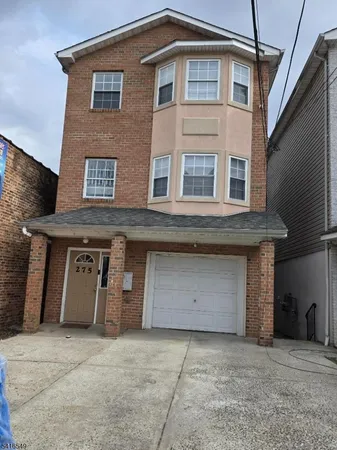 a front view of a house with garage
