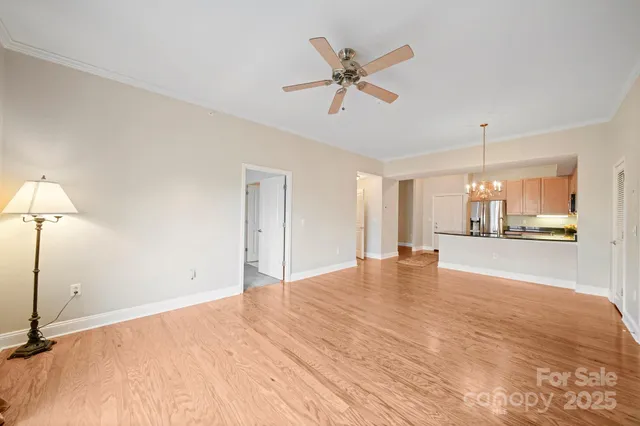 a view of a livingroom with a ceiling fan and window