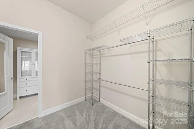 an empty room with a window and ceiling fan