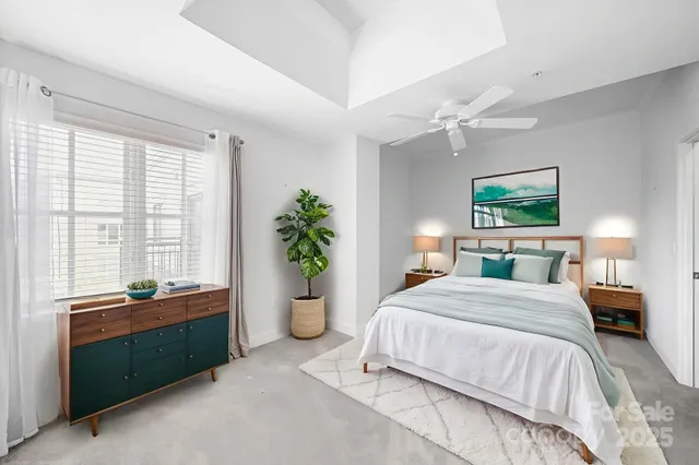 an empty room with a ceiling fan and a bathroom