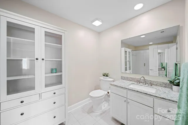 an empty room with a ceiling fan and a bathroom