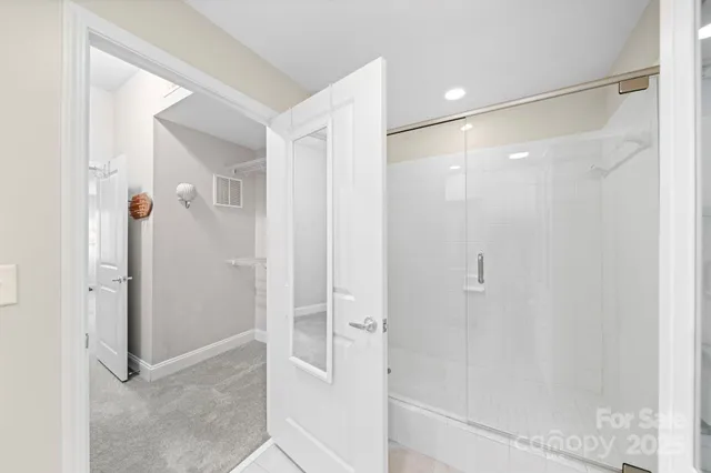 a view of walk in closet with empty racks