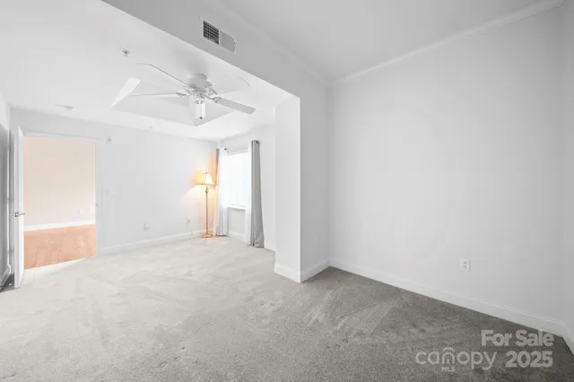 a living room with couches and a dining table with kitchen view