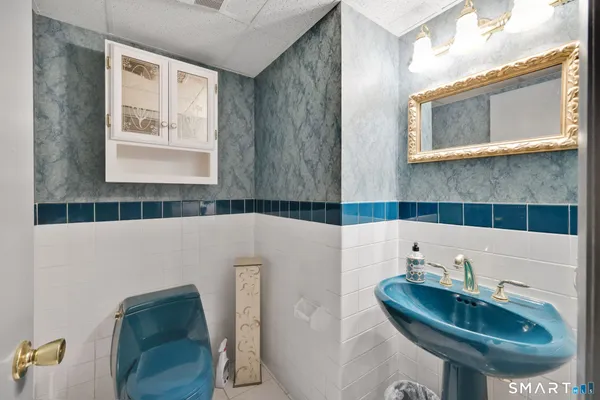 a bathroom with a sink a bathtub and a mirror